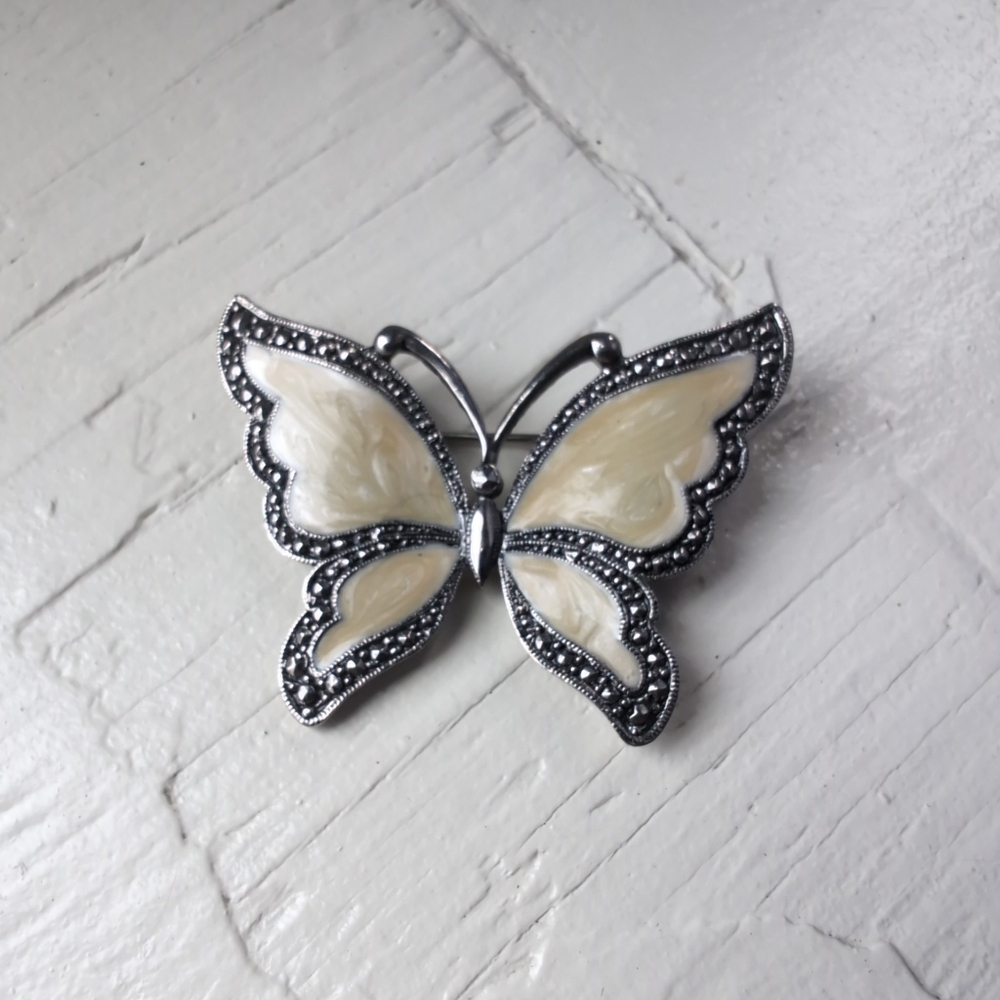Off white butterfly brooch with faux mother of pearl and marcasite silver tone